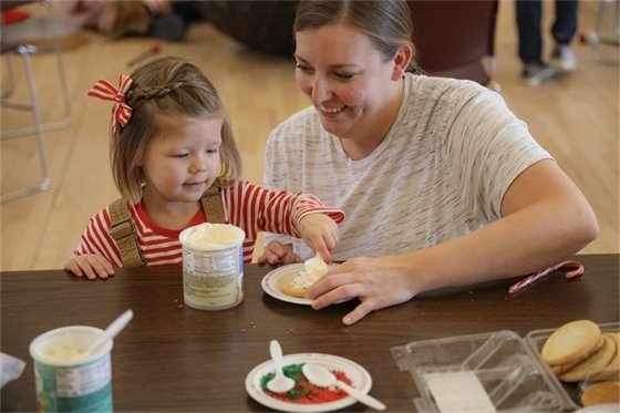 Mom and daughter decorating cookies