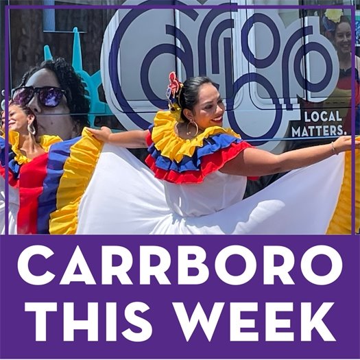 Takiri Folclor member in a colorful dress dancing in front of the Carrboro bus at Carrboro in Motion