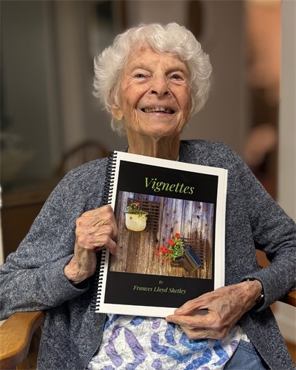 Frances Shetley proudly posing with her new book Vignettes