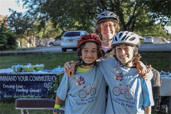 A family poses with their free "cycling is fun" t-shirts from the Bike Breakfast on the way to school