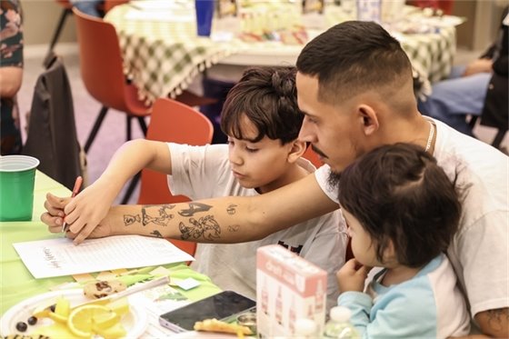 family plays game at PD baby shower