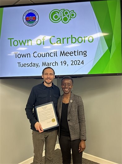 Mayor Foushee with Fleet Feet representative with proclamation