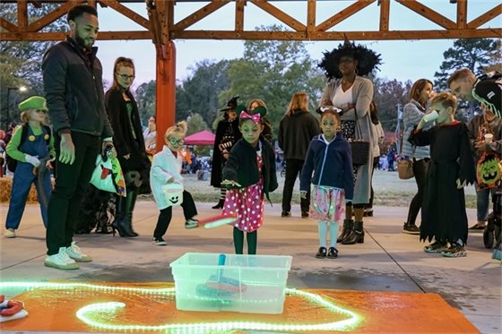 Children playing carnival games at the 2022 Halloween Carnival