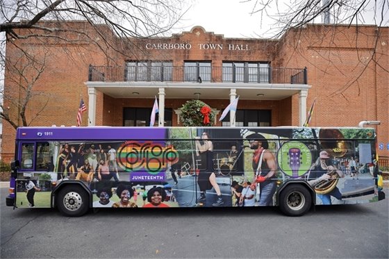 Bus with new Carrboro design in front of Town Hall