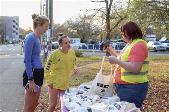 Planning staff handing out reflective gear on the Libba Cotten Bikeway