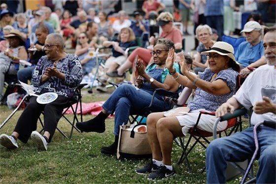 Carrboro Community claps along with music from a Freight Train Blues Concert at Carrboro Town Commons