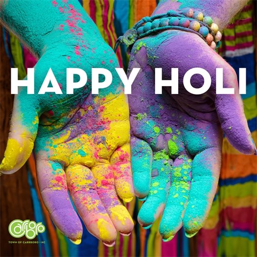 outstretched hands covered in paint celebrating Holi