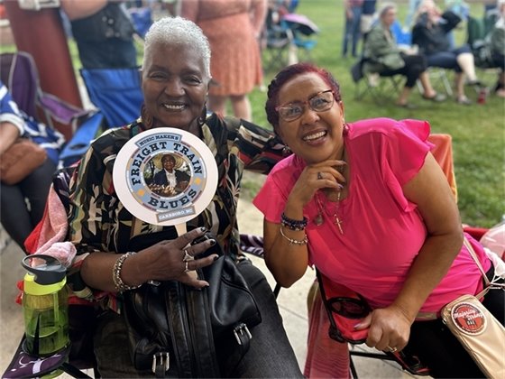 A crowd is enjoying music at Carrboro Town Commons at a Freight Train Blues Concert