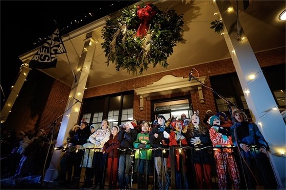 children singing on the steps of Carrboro Town Hall during the 2024 Tree Lighting