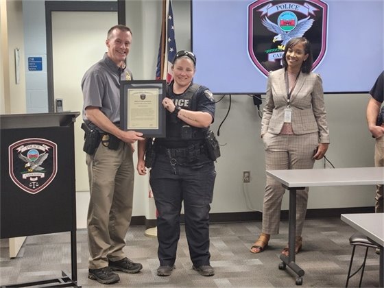 Officer Kimrey receiving an Official Commendation from Chief Atack