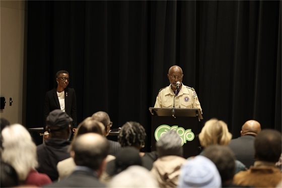 Mayor Barbara Foushee watching as Braxton Foushee address the crowd gathered in his honor