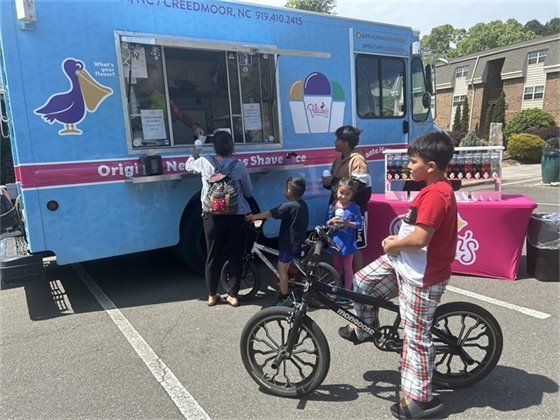Residents at Collins Crossing Apartments enjoy a SnoBall from Pelicans SnoBalls